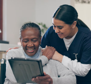 Caregiver and senior smiling