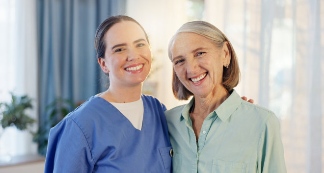 caregiver and senior woman smiling