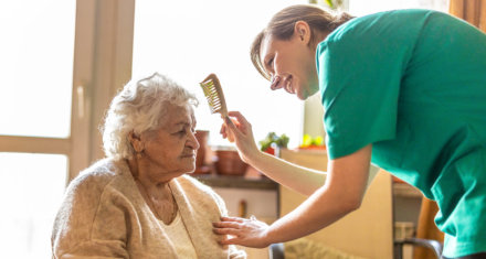 Female nurse comb the hair of the senior woman