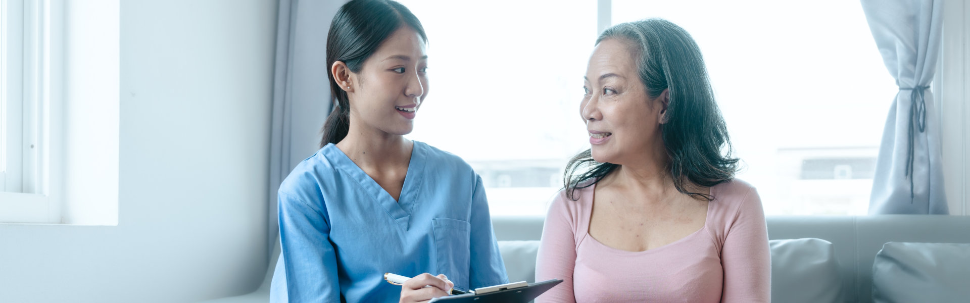 caregiver and senior woman smiling