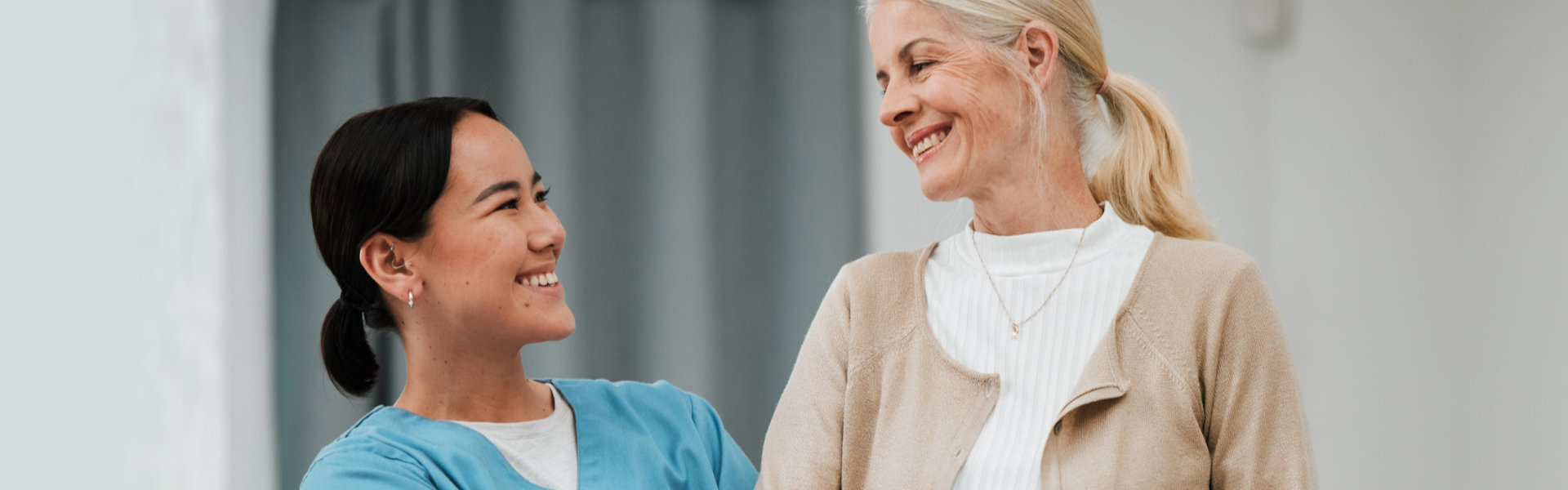 caregiver and senior woman smiling
