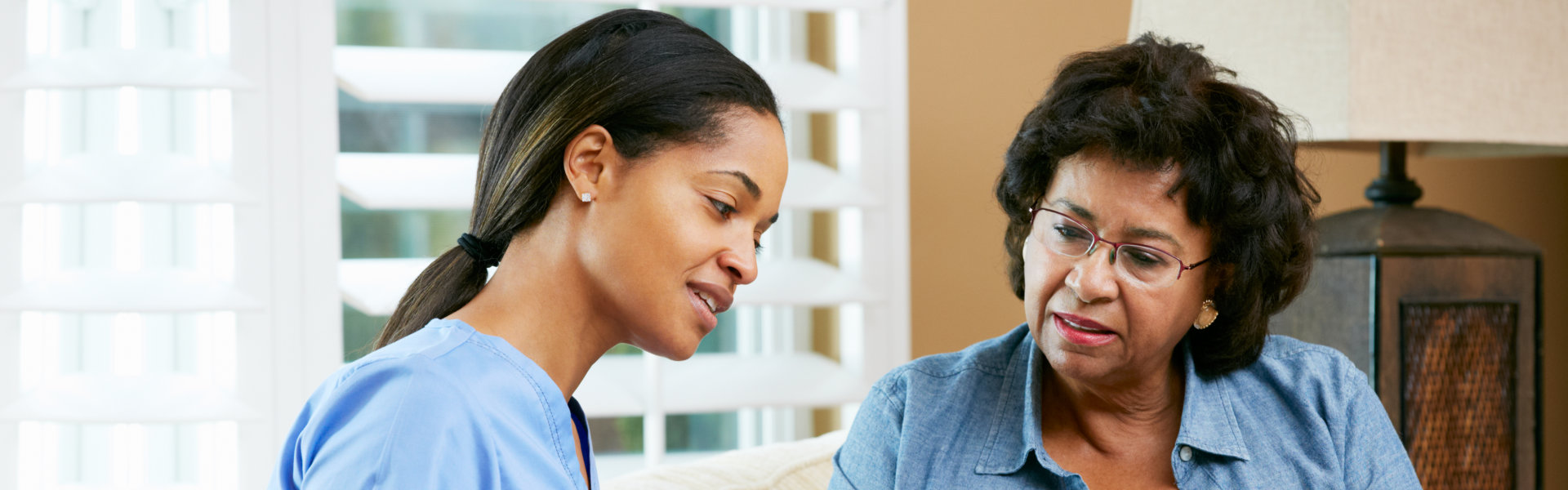 caregiver talking to senior woman